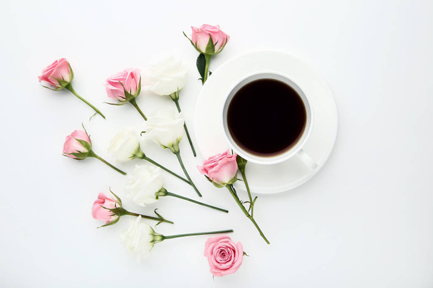 Rose flowers with cup of coffee on white background - Foto, Imagem