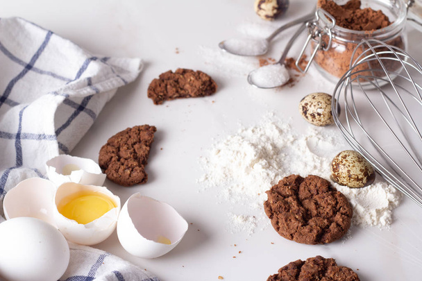 chocolate chip cookies and baking ingredients on a white marble backgroun - Φωτογραφία, εικόνα