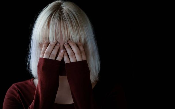Portrait of sad depressed young woman on black background  - Foto, Imagem