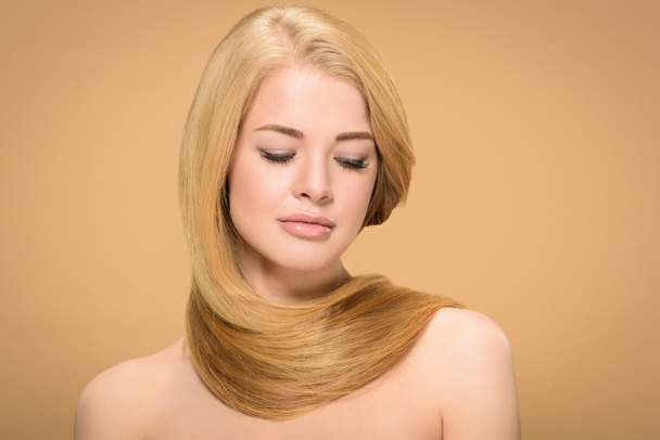 Relaxed woman posing with long hair around neck - Photo, image