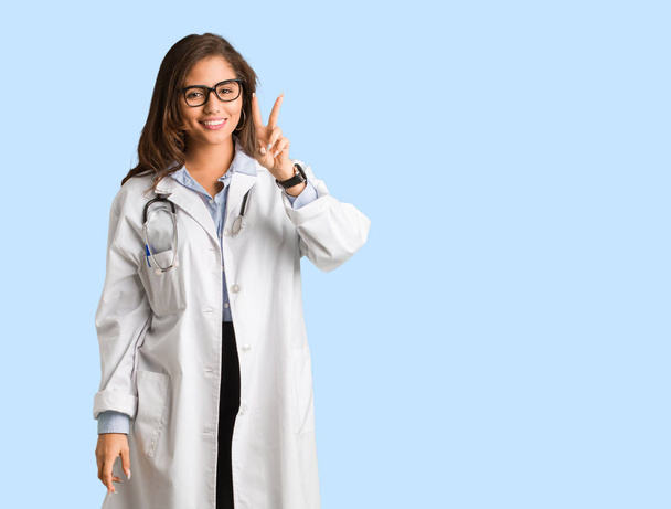 Full body young doctor woman showing number two - Photo, image
