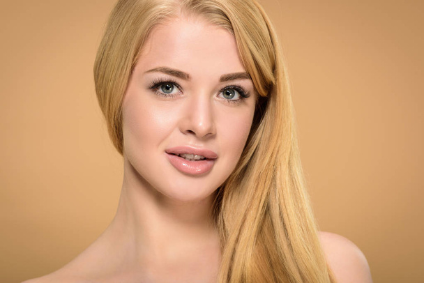 Studio shot of blonde young woman with grey eyes  - 写真・画像