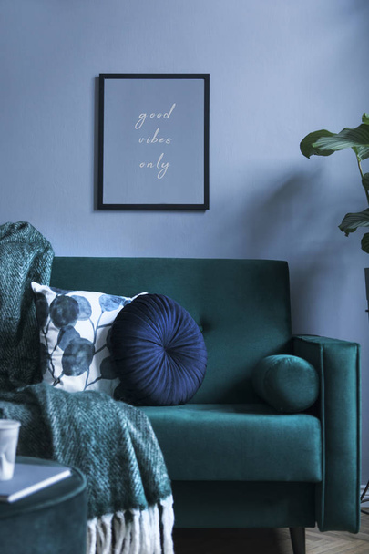 Grey luxury interior with green velvet sofa, pillows, pouf, blanket and tropical plant. Modern composition with mockup image. Brown wooden parquet. - Φωτογραφία, εικόνα