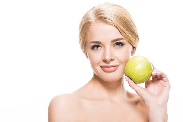 beautiful naked blonde girl holding fresh apple and smiling at camera isolated on white - Photo, Image