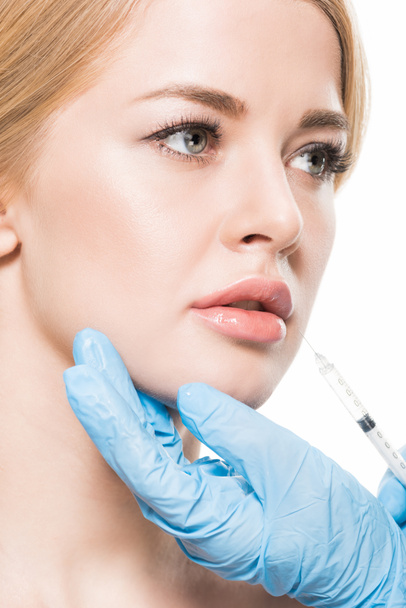 красивая молодая женщина получает инъекции красоты в губы изолированы на белом
 - Фото, изображение