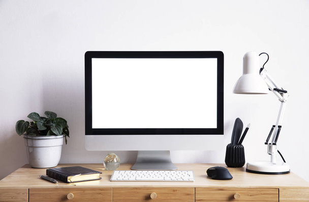 Blank stylish digital monitor on modern workplace  - Photo, image