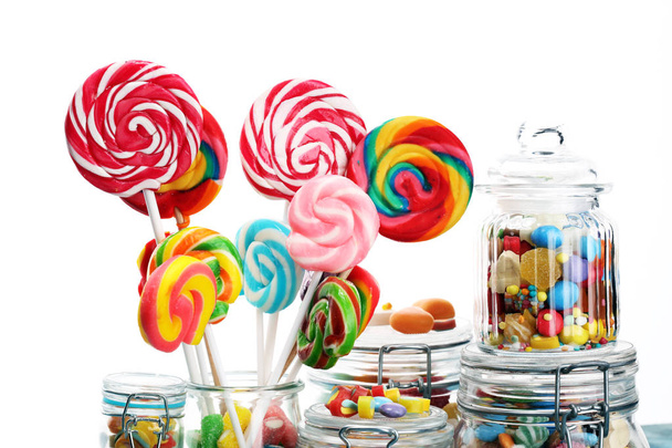 candies with jelly and sugar. colorful array of different childs sweets and treats in glass jar - Photo, Image