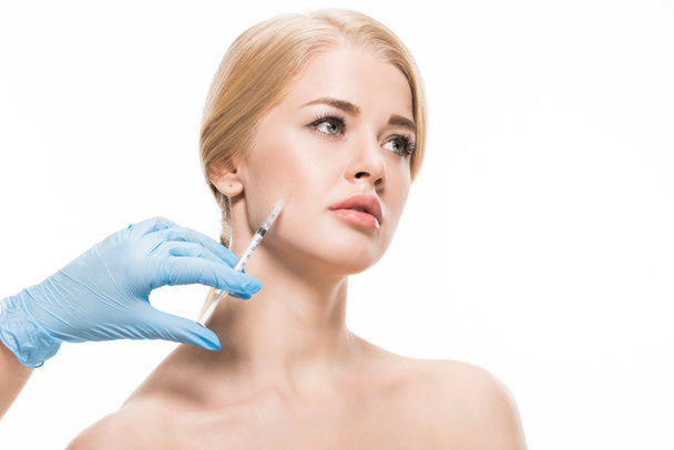 cropped shot of cosmetologist in latex glove making beauty injection to naked young woman isolated on white  - Foto, imagen