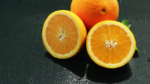Orange with leaf on wet table - Footage, Video