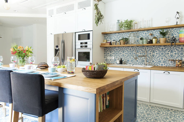 Light stylish kitchen in blue colors in Mediterranean style - Foto, afbeelding