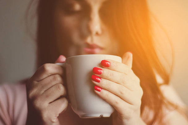 Young woman enjoying morning coffee  - Foto, Bild
