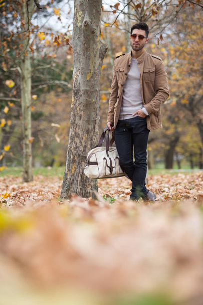 Young adult man handsome posing in the wood, winter autumn day - Fotoğraf, Görsel