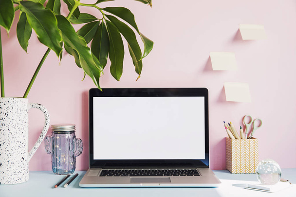 Modern work-space with laptop mock up screen and office accessories on pastel pink background  - Φωτογραφία, εικόνα