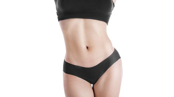 Female cropped fit body in black top and panties, isolated on white, woman puts her hands on her hips. Good shape figure. - Photo, Image