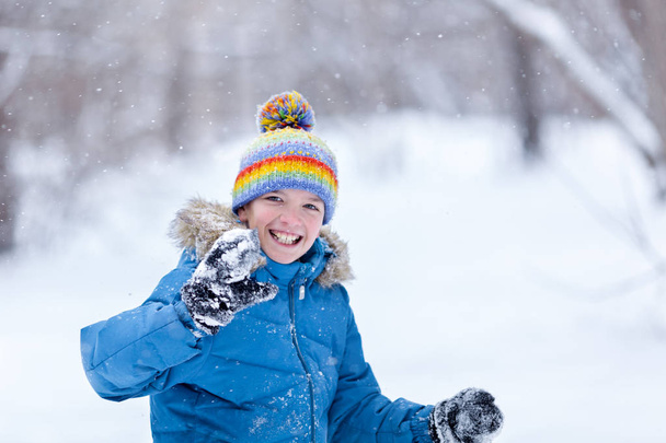 Portrait of cheerful happy boy playing in winter park, outdoor - Фото, изображение