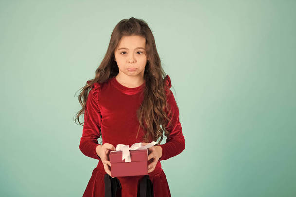 Unhappy girl in red dress hold present box - Fotó, kép