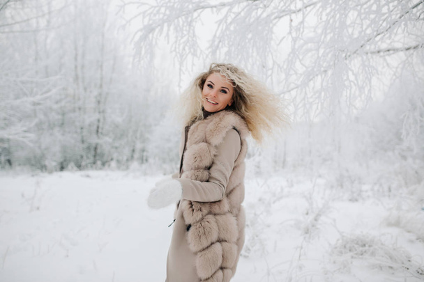Image of happy blonde woman on walk in winter forest - 写真・画像