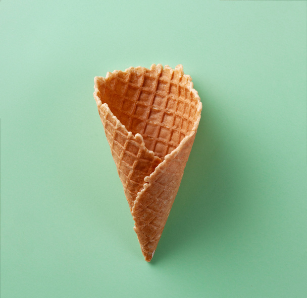Ice cream cone on green pastel background. Art. Flat lay - Photo, Image