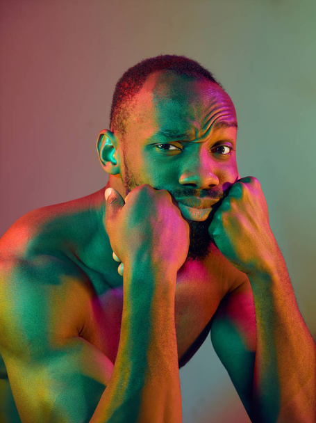 Close up portrait of a young naked african man looking at camera indoors - Foto, Imagem