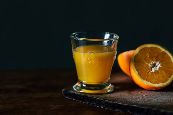 Oranges and glass of fresh juice on wooden table - Foto, immagini