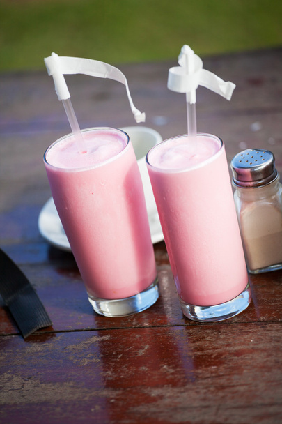Two glasses with strawberry milkshake and straws - Photo, Image