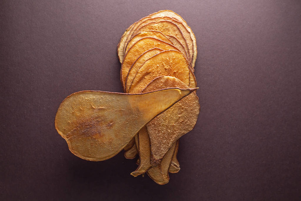 dried pears on brown background  - Foto, imagen