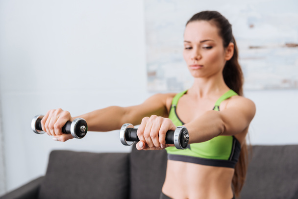 sportswoman working out with dumbbells at home with copy space - Fotoğraf, Görsel