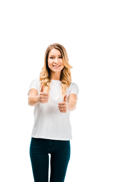 beautiful blonde girl in white t-shirt showing thumbs up and smiling at camera isolated on white - 写真・画像