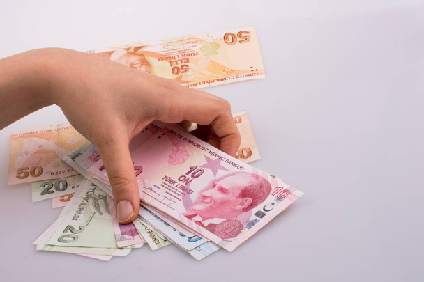 Kezében Turksh líra bankjegyeit fehér háttér - Fotó, kép