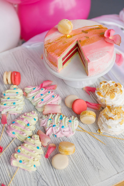 Beautiful pastry. cakes and macaroons. Sweet holiday buffet with cupcakes, cakes and other sweet desserts - 写真・画像