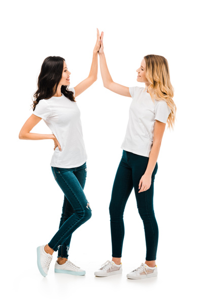 happy young women giving high five and smiling each other isolated on white - Φωτογραφία, εικόνα
