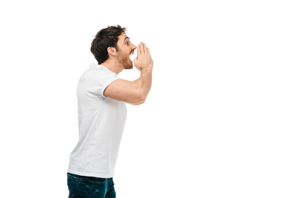 side view of man in white t-shirt screaming and looking away isolated on white - Fotó, kép