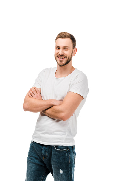handsome happy young man standing with crossed arms and smiling at camera isolated on white - Photo, Image