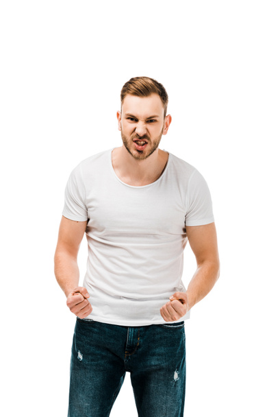 angry young man standing with clenched fists and looking at camera isolated on white - Fotografie, Obrázek