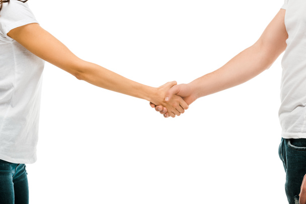 cropped shot of young man and woman shaking hands isolated on white - Foto, imagen