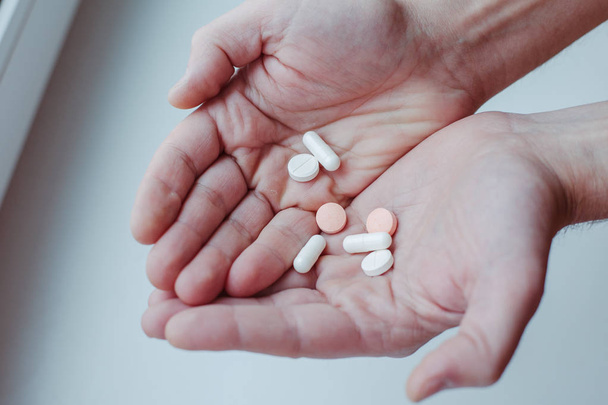 Pills in hand isolated on white - Valokuva, kuva