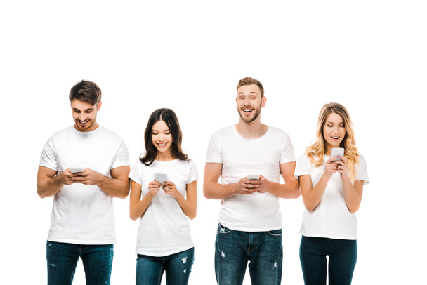 happy young men and women in white t-shirts using smartphones isolated on white - Fotoğraf, Görsel