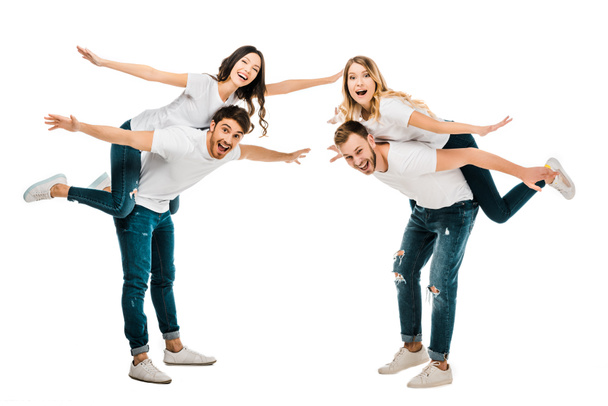 happy young couples piggybacking and smiling at camera isolated on white - Fotografie, Obrázek