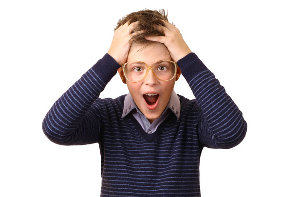 Surprised teenager in glasses holds his head - Photo, Image