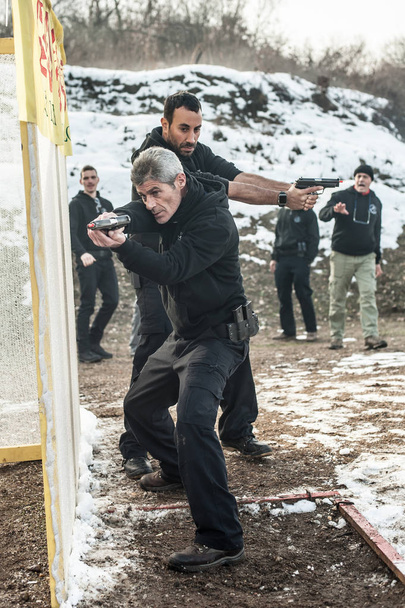 Pozarevac, Serbia - December 21-24, 2018: Large group of kapap students practice action gun shooting on target in the shooting range GROM on KAPAP BASIC FIREARMS SAFETY AND GUN USE SEMINAR - Foto, immagini