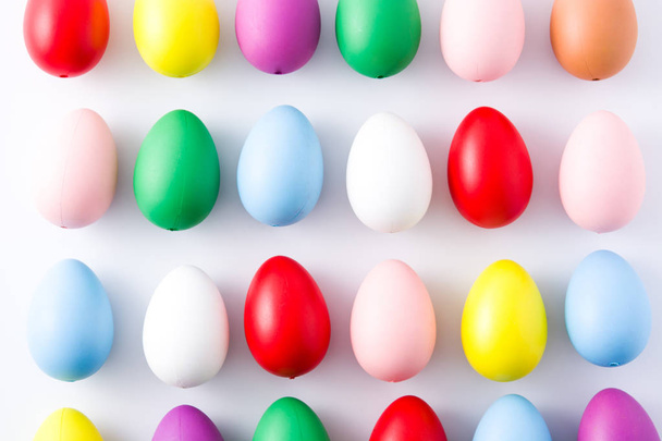 Easter holidays concept with colorful easter eggs pattern on white background. Close up  - Fotó, kép