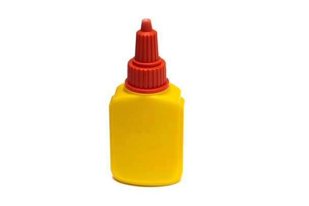 Yellow container with glue close up, isolate on a white background - Photo, Image