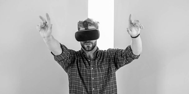 Interaction in virtual reality with digital surface. Man unshaven guy with VR glasses, pink background. Hipster use modern technologies for entertainment. Guy with VR glasses or head mounted display - Fotoğraf, Görsel