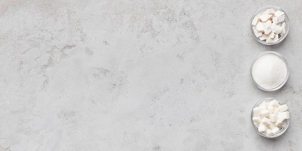Collection of different kinds of sugar on gray background - Photo, Image