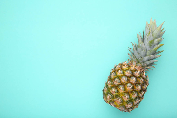 Fresh pineapple on a mint background - Foto, afbeelding