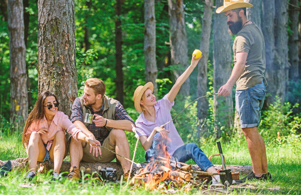Camping and hiking. Company friends relaxing and having snack picnic nature background. Great weekend in nature. Company hikers relaxing at picnic forest background. Halt for snack during hiking - Zdjęcie, obraz