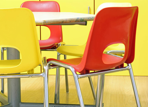 msall red and yellow chairs in the classroom of a kindergarten without children - Fotoğraf, Görsel