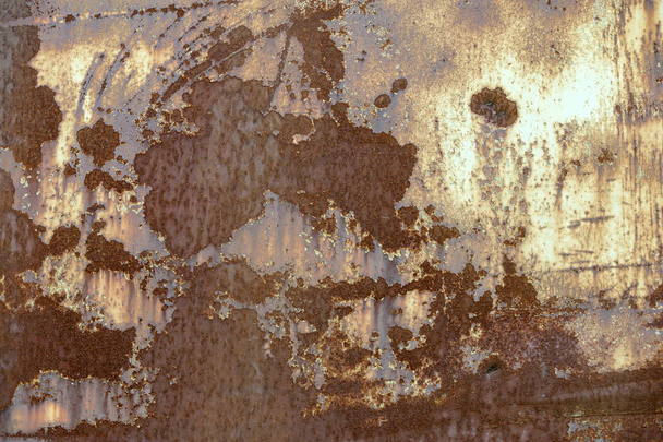 Old cracked abstract grunge vintage texture copy space sunny background, retro pattern. White irregular spots paint peeling of brown concrete or wooden wall or ceiling flat surface. - Photo, Image