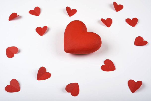 Big red heart on white background many paper hearts. Valentines Day. - Fotografie, Obrázek