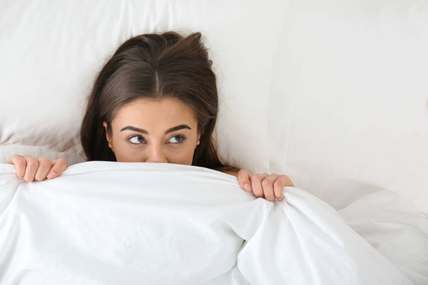 Young woman lying under blanket, top view. Bedtime - Fotografie, Obrázek